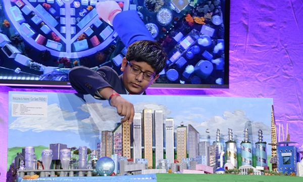 Vinay Ayalya with his team's winning model city, “Halona”