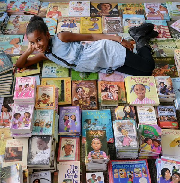 Marley Dias with some of the books that she has collected