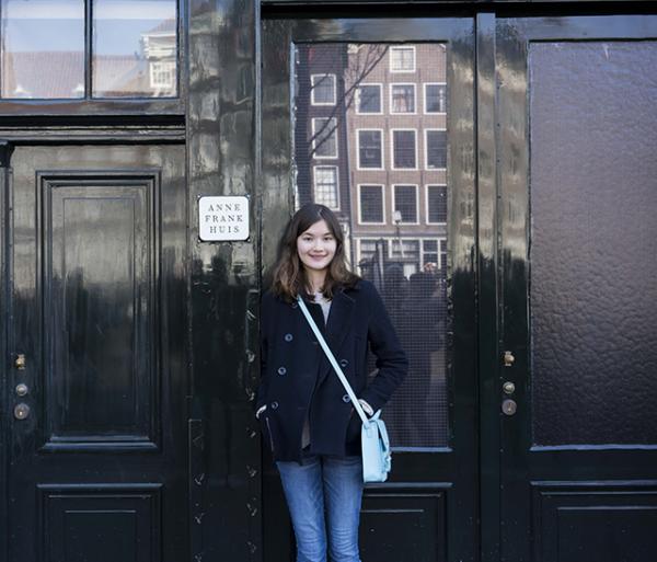 Charlotte stands outside the house in which Anne Frank hid. It’s located in the back of her father’s office building, in the heart of Amsterdam.