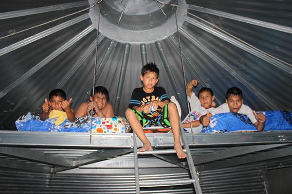 Kids climbing in the loft of a Safe T Home. Photo by Sukup Manufacturing