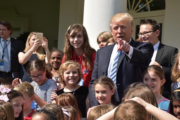 President Donald Trump with Lillian (to his right) and other kids in the Rose Garden of the White House. 