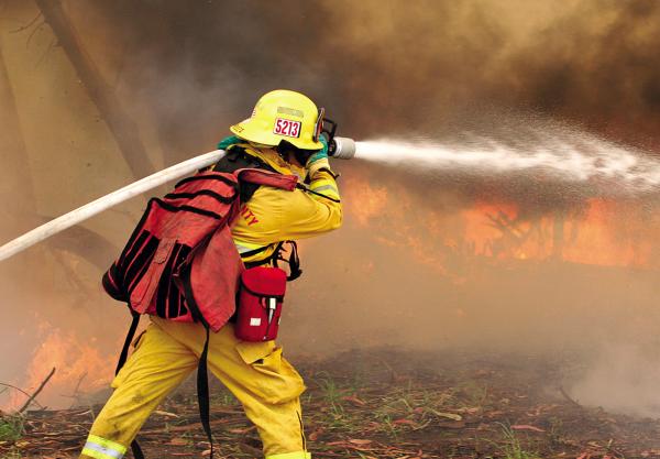 Firefighter Joel Mendoza chases down a wall of flames in Las Lomas, California.
