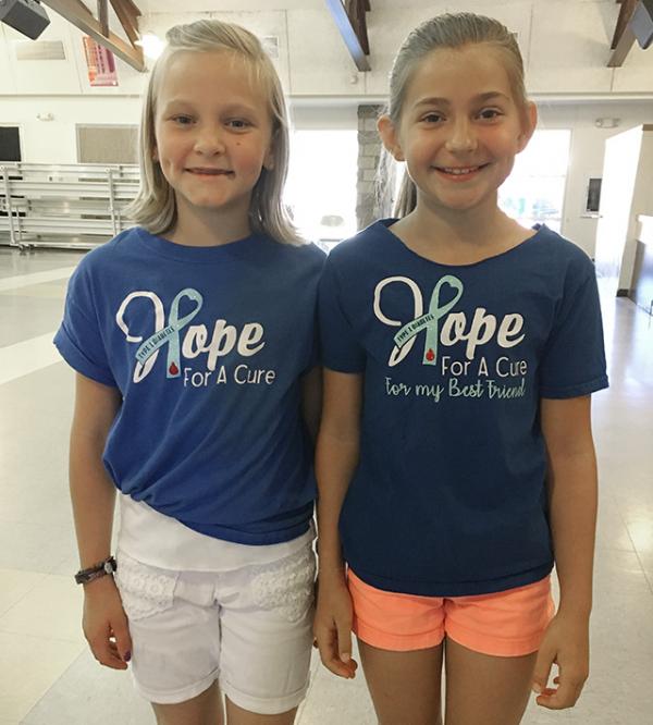 Best friends Ella and Saylor with ‘Hope For a Cure’ t-shirts.