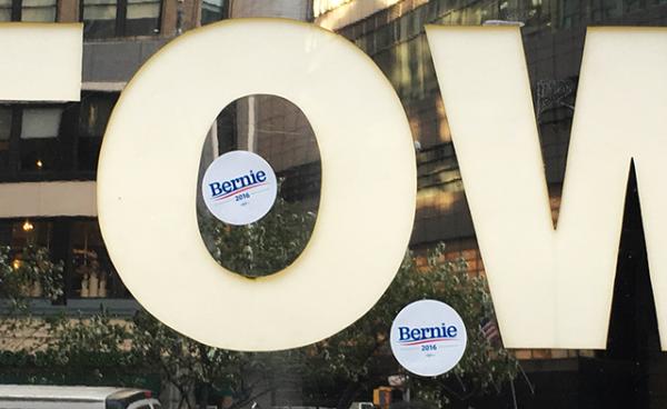 Bernie Sanders stickers on a Trump Tower sign. The New York City building is owned by Republican candidate Donald Trump.