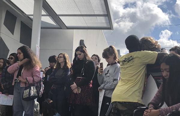 Students comfort each other during the reading of the 17 victim's names 