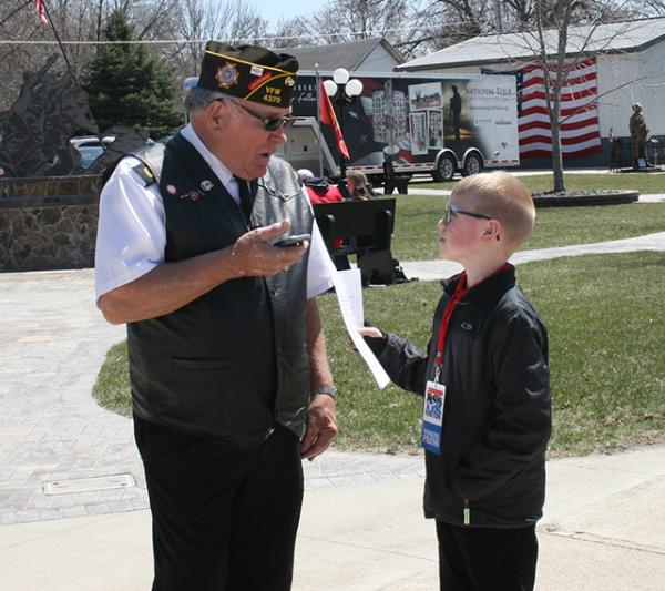 Brandon interviewing the event organizer, Jerry Christensen about why he brought the memorial to Britt, IA.