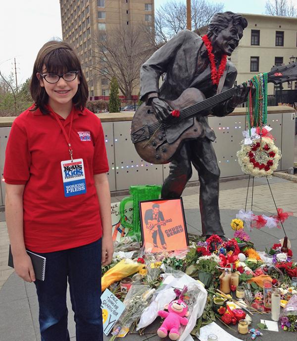 Esther in front of the statue of Chuck Berry in St. Louis