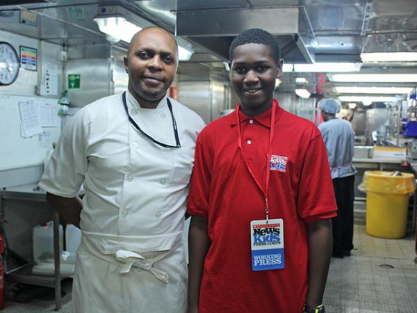 Caleb and chef Serge Nzembele in the galley of the ship