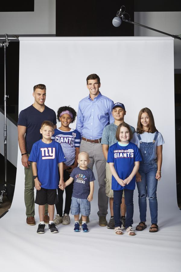 NFL quarterback Eli Manning with young patients at Hackensack University Health Center in New Jersey
