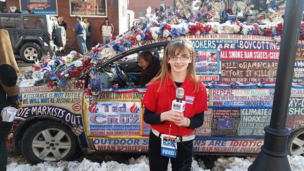 Kaitlin in front of a minivan that the owner transformed into a rolling billboard for Cruz