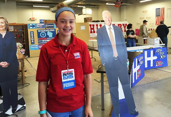 Lilian with cardboard cutouts of Clinton and Biden