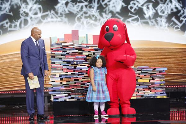 Daliyah with Steve Harvey and Clifford the Big Red Dog and the book donations that were made to Reach Out and Read in Daliyah’s honor