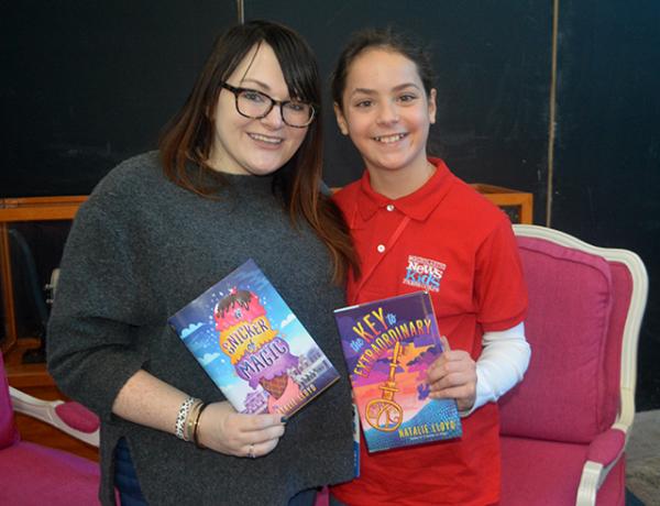 Sadie with author Natalie Lloyd displaying Lloyd’s two novels.