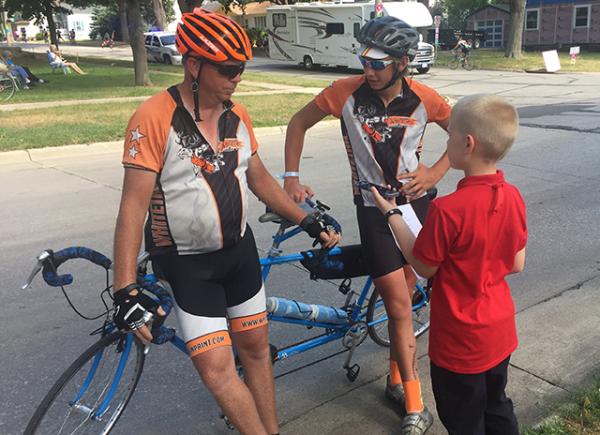 Paul Brasby and Erick Graff, both from Nebraska, discuss why they prefer RAGBRAI over the other rides they participated in across the nation.