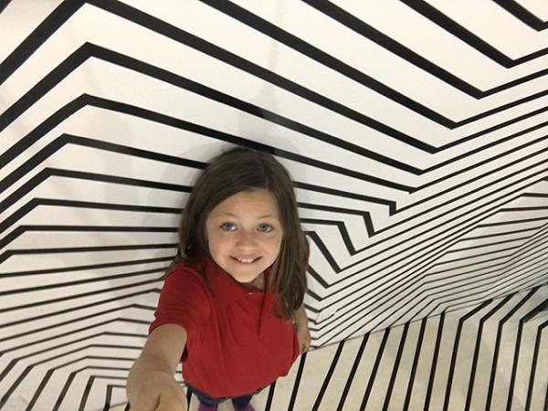 Kid Reporter gets creative in an optical illusion room. 