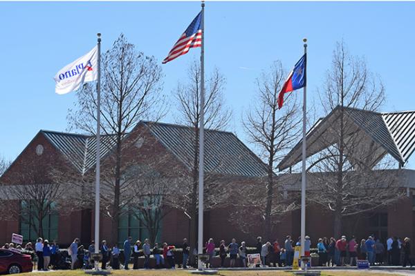 Voters line up at Maribelle Davis Library in Plano, Texas to vote in the presidential primaries