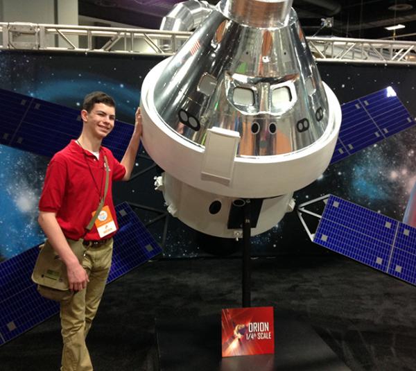 Erik Weibel in front of the ¼ scale Orion Spacecraft model. The Orion will carry a crew of 4 humans to Mars.