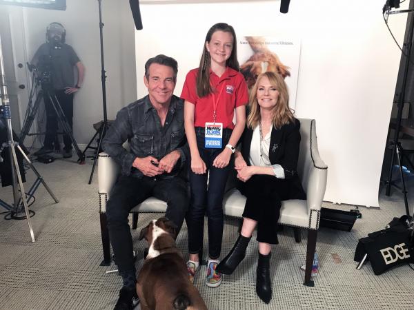 Kid Reporter Annika Petras stands with Dennis Quaid and Marg Helgenberger, stars of the new film, a Dog’s Journey. 