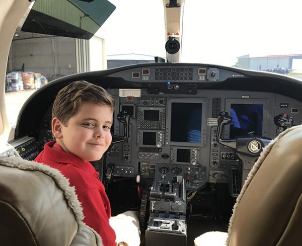 Truman in the cockpit of a plane filled with supplies for hurricane victims in Houston