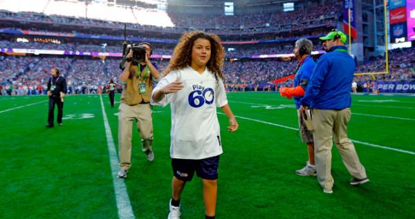 Bobby Sena, winner of this year's NFL PLay 60 Super Kid contest, runs across the field before Super Bowl XLIX.