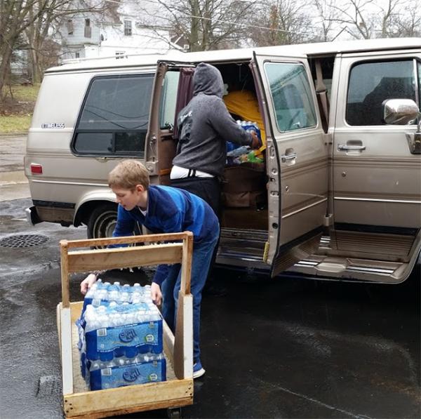 Benjamin helps deliver water to families in Flint, Michigan.