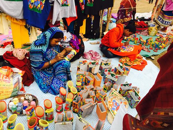 Craftspeople painting at the fair