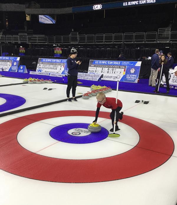 Brandon is getting his first chance learning how to curl.