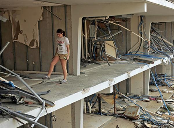 A girl walks through her ruined apartment building in Biloxi, Mississippi. Hurricane Katrina caused extensive damage in the Southeast in August 2005.