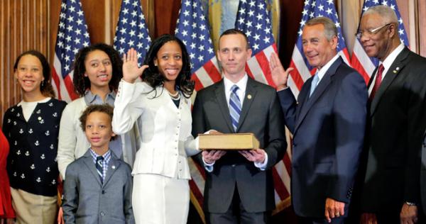 House Speaker John Boehner administers a ceremonial oath of office to Representative Mia Love of Utah in January in Washington, D.C., as Love’s family looks on. House Speaker John Boehner administers a ceremonial oath of office to Representative Mia Love of Utah in January in Washington, D.C., as Love’s family looks on.