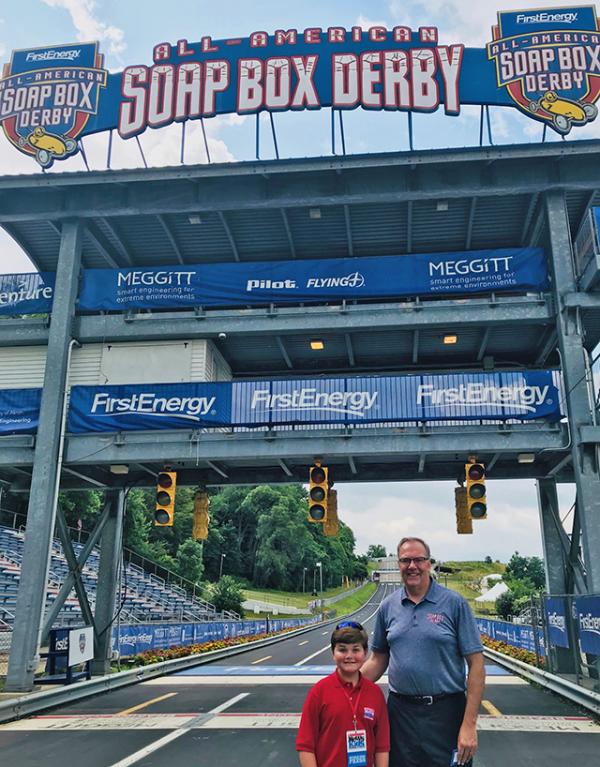 Nolan at the finish line with Mark Gerberich, president, and CEO of the Soap Box Derby