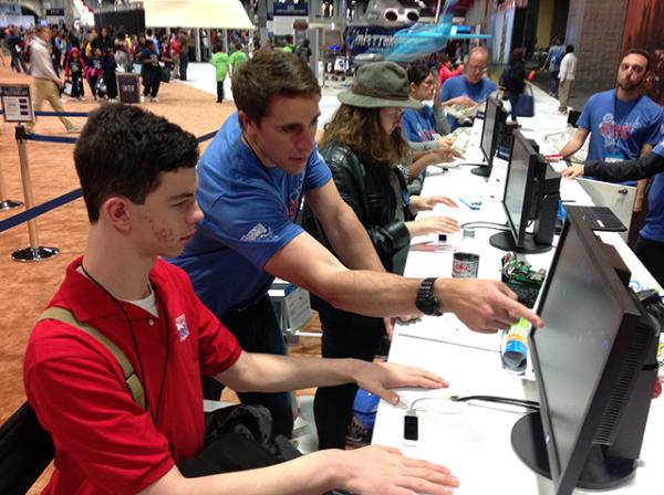 David Coar an Engineer with Lockheed Martin shows Erik Weibel how they are developing hands-free technology to steer rover vehicles to investigate other planets. “We are representing future technology.”