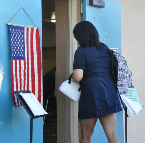 A young voter, Ipod in hand, goes to the polls in Los Angeles.