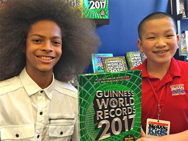 Kid Reporter Joshua Yi (right) with Tyler Wright, world-record holder for largest male afro
