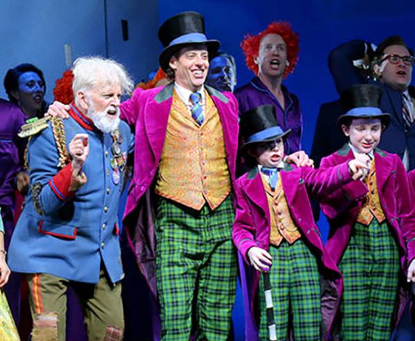 Cast members of Charlie and the Chocolate Factory, a new musical on Broadway, after a recent performance. The show is based on Roald Dahl’s novel of the same name. It stars Christian Borle, center, as Willy Wonka, the eccentric owner of a chocolate factory.
