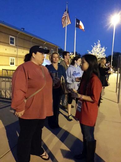 Bridget speaks with Amy Robinson while she waits in line to cast her vote in the Texas primaries.