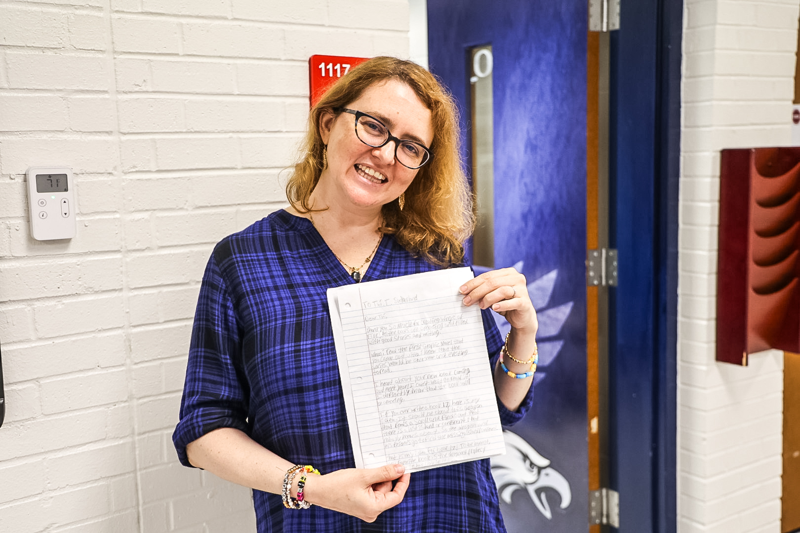 Author Tui Sutherland pictured with a drawing of a dragon