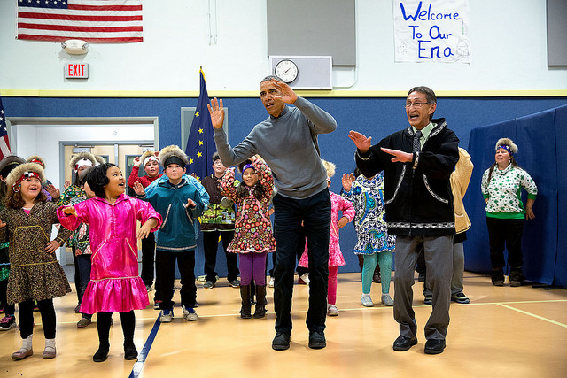 The President joins locals during a cultural dance performance at Dillingham Middle School in Dillingham, Alaska.