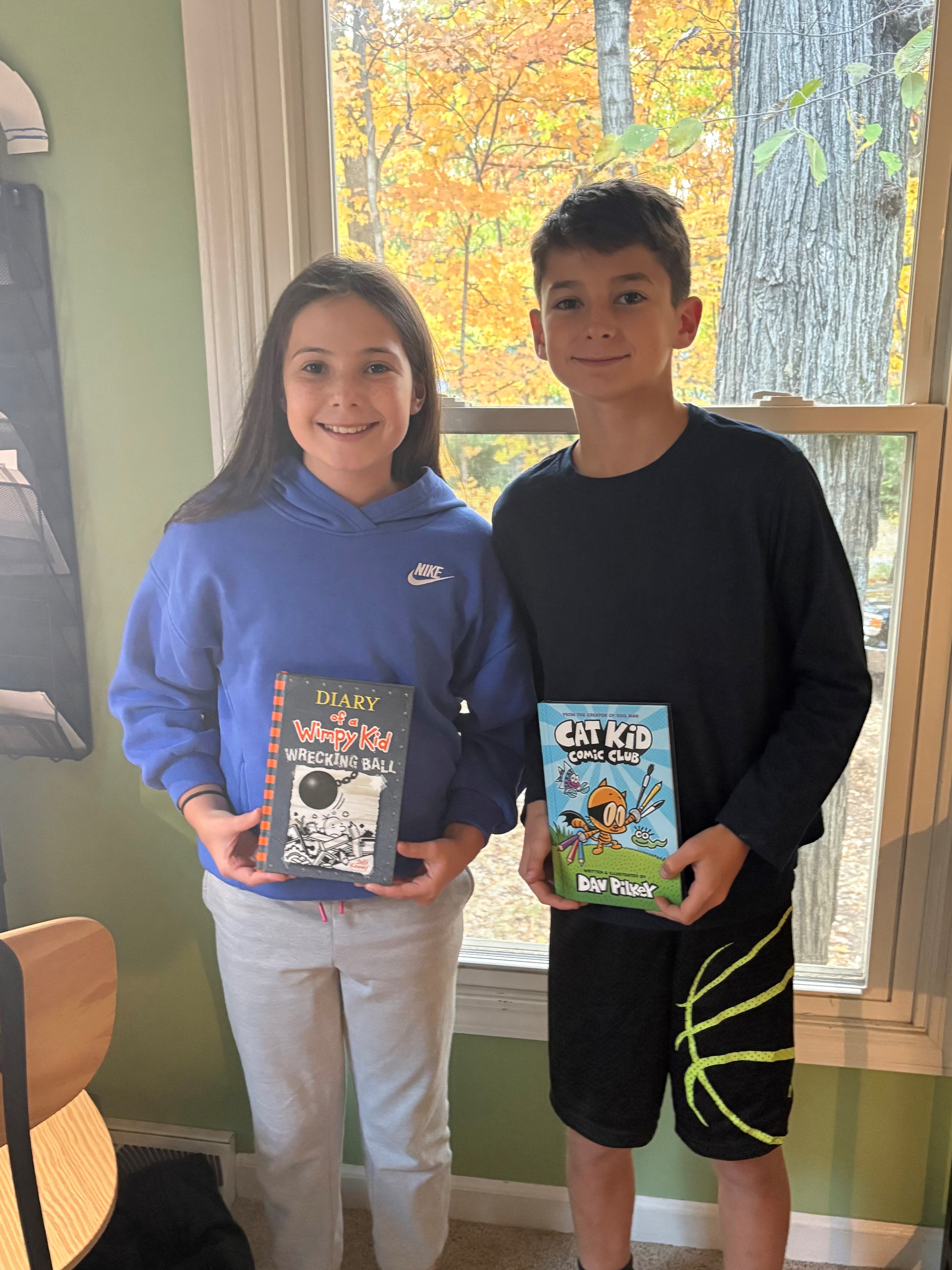 Kid Reporter Asher Freije and Tatum show off their favorite graphic novels. 