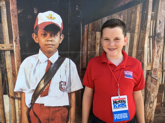 Ryan in front of a Compassion Experience exhibit