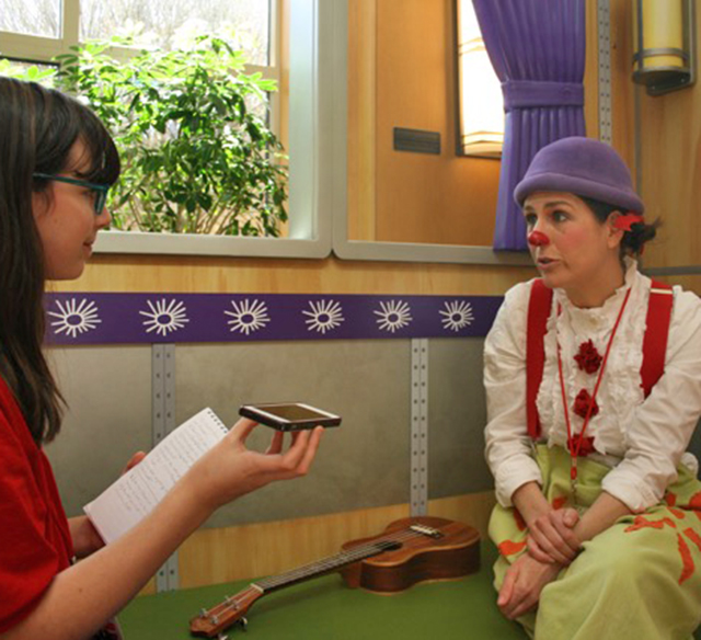 Esther Appelstein talks with Claire Wedemeyer from Clowns on Call before a performance.