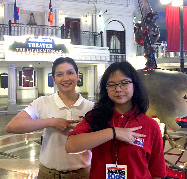 Pinky Laurena, Minister of Visitor Experience at KidZania Manila, and Georgia gesture “hello,” or “kai,” the KidZania way.