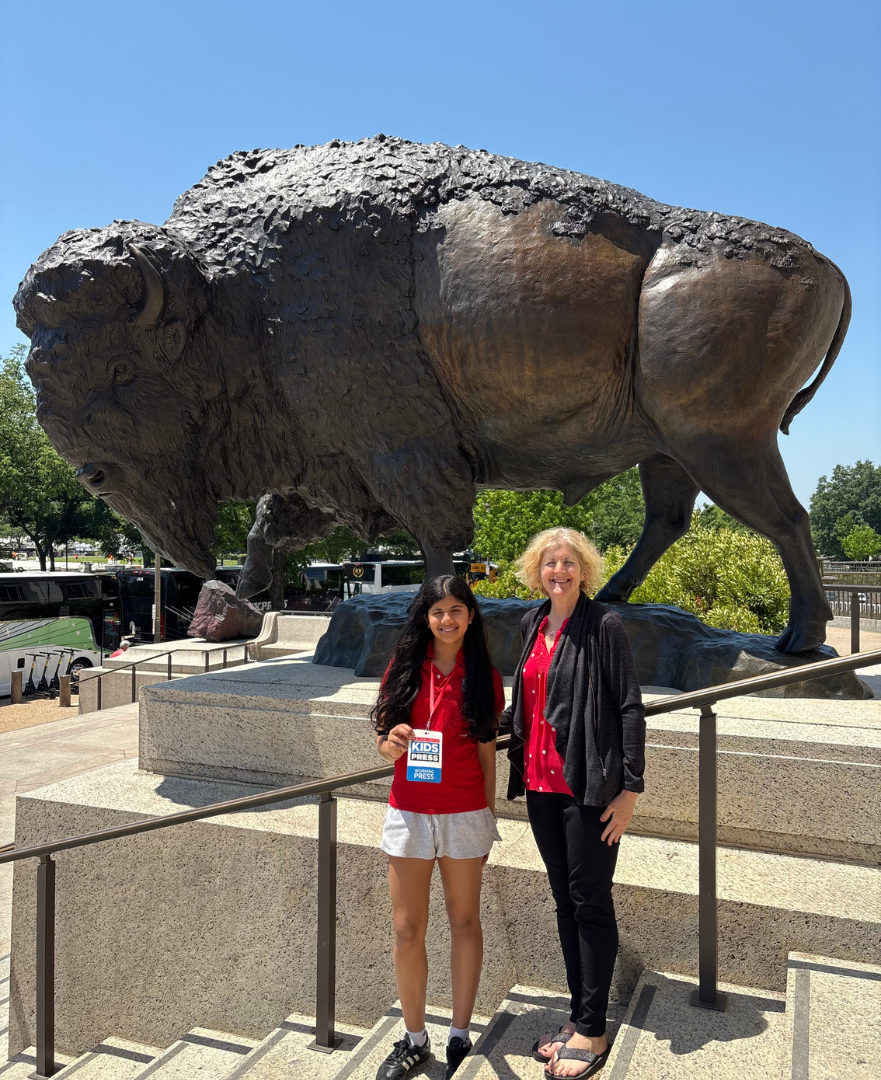 Scholastic Kid Reporter Leyla Saldanha standing in front of a bronze bison statue with Siobhan Starrs, Exhibition Developer and Project Manager at the Smithsonian. Scholastic Kid Reporter Leyla Saldanha standing in front of a bronze bison statue with Siobhan Starrs, Exhibition Developer and Project Manager at the Smithsonian.