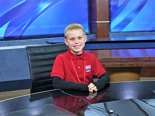 Brandon tries out the news anchor desk at KIMT