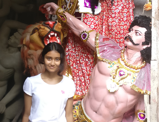 Scholastic Kid Reporter Roopkatha Roy in front of a  workshop at Kumartuli