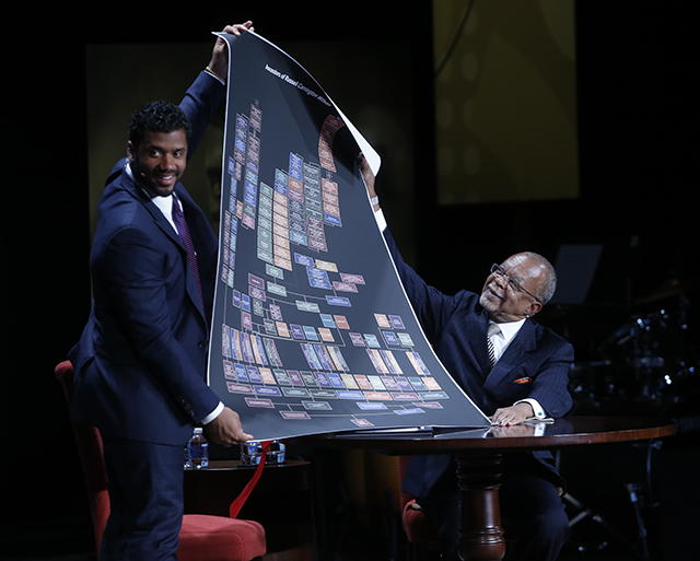 Gates presents Wilson with a paper copy of his complete family tree.