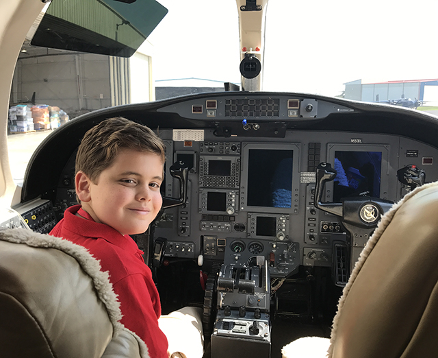 Truman in the cockpit of a plane filled with supplies for hurricane victims in Houston