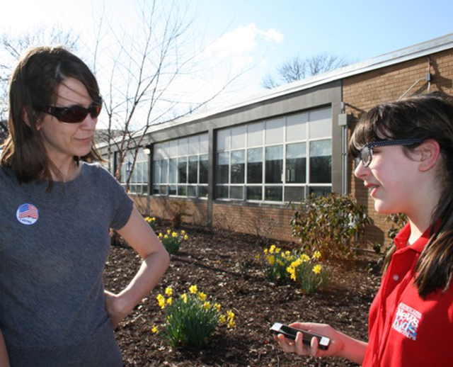 Esther talks with voter Beth Veccaro.