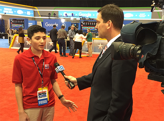 Scholastic News Kid Reporter Gabriel Ferris is interviewed by a TV reporter at a debate in New Hampshire.