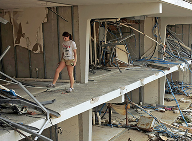 A girl walks through her ruined apartment building in Biloxi, Mississippi. Hurricane Katrina caused extensive damage in the Southeast in August 2005.