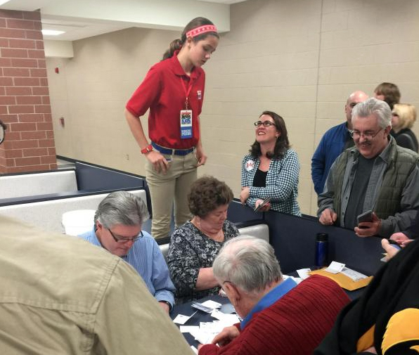 Lilian watches votes being counted at a Republican caucus at Urbandale High School in Iowa.